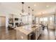 Open-concept kitchen with a large island, granite countertops, pendant lighting, and a view of the living room at 21855 E Idyllwilde Dr, Parker, CO 80138