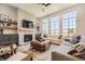 Bright living room with a fireplace, hardwood floors, and large windows at 21855 E Idyllwilde Dr, Parker, CO 80138