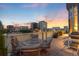 Outdoor balcony with comfortable seating, grill, and views of the city skyline, perfect for relaxing and entertaining at 55 W 12Th Ave # 608, Denver, CO 80204