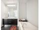 Modern bathroom featuring double sinks, sleek cabinets, and a soaking tub at 55 W 12Th Ave # 608, Denver, CO 80204