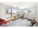 Sunlit bedroom featuring city views, a cozy sitting area, and modern furnishings at 55 W 12Th Ave # 608, Denver, CO 80204