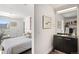 Bright bedroom featuring a comfortable bed and an adjacent bathroom area at 55 W 12Th Ave # 608, Denver, CO 80204
