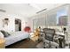 Bright bedroom with a modern desk area, a balcony, and natural light through large windows at 55 W 12Th Ave # 608, Denver, CO 80204