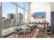 A dining area featuring expansive windows, city views, and modern decor creates an elegant and inviting space at 55 W 12Th Ave # 608, Denver, CO 80204