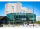 Exterior of a contemporary building featuring a round glass facade and city views at 55 W 12Th Ave # 608, Denver, CO 80204