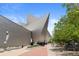 Striking exterior of a modern building featuring unique architectural design and street access with trees at 55 W 12Th Ave # 608, Denver, CO 80204