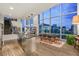 Modern kitchen featuring a stainless steel island, sleek cabinetry, hardwood floors, and large windows with stunning city views at 55 W 12Th Ave # 608, Denver, CO 80204