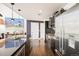 Modern kitchen with stainless steel appliances, dark wood cabinets, and a spacious island with sleek countertops at 55 W 12Th Ave # 608, Denver, CO 80204