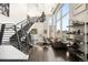 Spacious living room with high ceilings, floor-to-ceiling windows, hardwood floors, and a staircase at 55 W 12Th Ave # 608, Denver, CO 80204