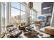 A modern living room with floor-to-ceiling windows, stylish furniture, and a view of the city skyline at 55 W 12Th Ave # 608, Denver, CO 80204