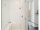 All-white tile shower with built-in bench and glass enclosure at 55 W 12Th Ave # 608, Denver, CO 80204