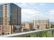 City view from balcony with mountains in the distance at 55 W 12Th Ave # 608, Denver, CO 80204