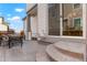 The covered patio features stamped concrete, outdoor seating, and sliding glass doors to the home's interior at 6041 N Orleans St, Aurora, CO 80019