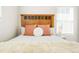 Cozy bedroom with wood headboard, neutral bedding, and side table with lamp at 6041 N Orleans, Aurora, CO 80019