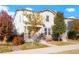 Charming two-story home featuring stone accents, a covered porch, and mature trees at 6041 N Orleans, Aurora, CO 80019