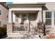 Charming front porch with stone pillars, a cozy seating area, and clear house number for easy identification at 6041 N Orleans, Aurora, CO 80019