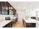 Contemporary kitchen with stainless steel appliances, white countertops, and dark cabinetry at 6041 N Orleans, Aurora, CO 80019