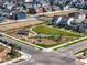 Aerial view showcasing a community park with a playground, picnic area, and walking paths in a residential area at 6041 N Orleans St, Aurora, CO 80019