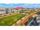 Aerial view of community featuring a large grassy field, walking paths, and well-maintained landscaping at 6041 N Orleans St, Aurora, CO 80019