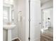 Bright powder room featuring modern sink, fixtures, and open doorway at 6041 N Orleans St, Aurora, CO 80019