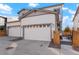 Exterior of property showing two car garage with driveway, front landscaping, and covered front porch area at 6041 N Orleans St, Aurora, CO 80019