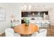 Modern kitchen featuring dark cabinets, stainless steel appliances, and a white countertop island with seating at 6041 N Orleans St, Aurora, CO 80019