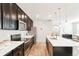 Spacious kitchen with dark cabinetry, a stainless-steel refrigerator, and an island with a sink at 6041 N Orleans St, Aurora, CO 80019