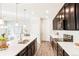 Bright kitchen with dark cabinets, stainless steel appliances, and a large island perfect for entertaining at 6041 N Orleans St, Aurora, CO 80019