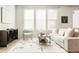 Bright living room featuring a neutral color palette, large windows, and stylish modern decor at 6041 N Orleans St, Aurora, CO 80019