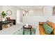 Open-concept living room with a leather sofa, round coffee table, and decor in a neutral color palette at 6041 N Orleans St, Aurora, CO 80019