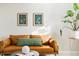 Cozy living room featuring a leather sofa, botanical artwork, and a stylish side table at 6041 N Orleans St, Aurora, CO 80019