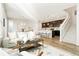 Open-concept living area with a sofa, rug, and kitchen island creating a welcoming space at 6041 N Orleans St, Aurora, CO 80019