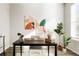 Modern office with sleek desk, artwork, decorative plants, and natural light from a window at 6041 N Orleans St, Aurora, CO 80019