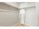 A white robe on a hanger inside a walk-in closet with shelving and neutral carpet at 6041 N Orleans St, Aurora, CO 80019
