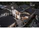 Aerial view of a modern home in a tranquil neighborhood, featuring a dark roof, large windows and a private backyard at 1175 S Jackson St, Denver, CO 80210