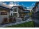 The backyard boasts a cozy patio area, lush landscaping, and modern architectural design of this home at 1175 S Jackson St, Denver, CO 80210
