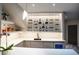 Basement bar features custom wine rack, counter seating, and sleek modern finishes at 1175 S Jackson St, Denver, CO 80210