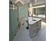 Bright bathroom featuring a modern shower, soaking tub, and vanity area at 1175 S Jackson St, Denver, CO 80210