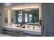 Bright bathroom with a large lighted mirror, double sink vanity, and modern fixtures at 1175 S Jackson St, Denver, CO 80210