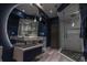 Sleek bathroom boasts an illuminated round mirror, glass shower, and modern fixtures at 1175 S Jackson St, Denver, CO 80210