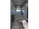 Stylish bathroom showcases a tiled shower, modern vanity, and gray color palette at 1175 S Jackson St, Denver, CO 80210