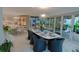 Well-lit dining room boasts modern lighting, comfortable seating, and easy access to the modern kitchen and patio at 1175 S Jackson St, Denver, CO 80210