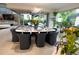 Bright dining room featuring modern lighting, table for eight, and sliding glass doors to the backyard at 1175 S Jackson St, Denver, CO 80210