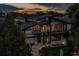 Eye-catching modern home featuring unique architectural design, large windows, and manicured front yard landscaping at 1175 S Jackson St, Denver, CO 80210