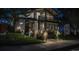 Well-illuminated modern home for sale at night with professionally landscaped front yard at 1175 S Jackson St, Denver, CO 80210