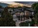 Aerial front view of a modern home with expansive windows, deck, professional landscaping, and inviting walkway at 1175 S Jackson St, Denver, CO 80210