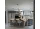 Stylish kitchen with a large center island, modern lighting, and an adjacent beverage cooler at 1175 S Jackson St, Denver, CO 80210