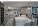 Modern kitchen featuring a waterfall island, sleek cabinetry, and stainless steel appliances at 1175 S Jackson St, Denver, CO 80210