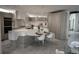 Contemporary kitchen with unique island design, integrated dining space, and light wood cabinetry at 1175 S Jackson St, Denver, CO 80210