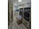Laundry room with front load washer and dryer, drawers and blue tiled backsplash at 1175 S Jackson St, Denver, CO 80210